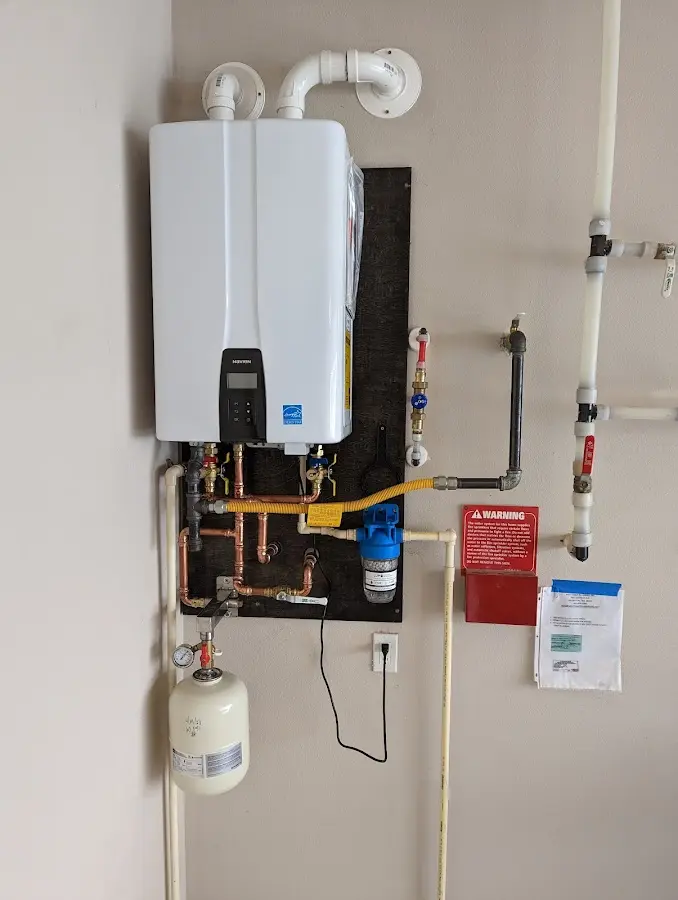 Professional plumber installing copper piping in a Stapleton home